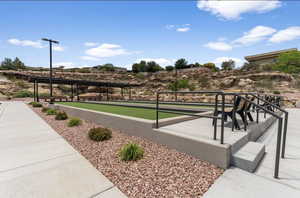 View of property's community with a bocce ball area and a patio