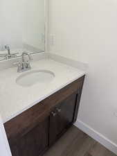 Bathroom with vanity and dark wood-style flooring