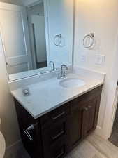 Bathroom featuring vanity and baseboards