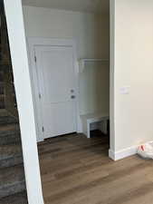 Mudroom featuring wood finished floors and baseboards