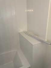 Full bathroom featuring a tub and a shower