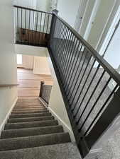 Staircase featuring baseboards and wood finished floors