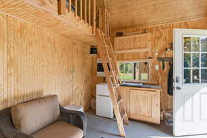Living area with concrete floors and wooden walls