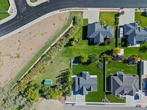 Aerial view of property and surrounding area featuring nearby suburban area