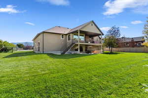 Back of property featuring stairway, a patio area, stucco siding, a mountain view, and a shingled roof