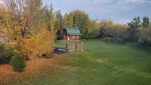 View of green lawn with an outbuilding