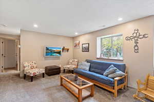 Living room with carpet flooring and recessed lighting