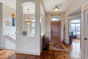 Foyer featuring wood-type flooring and a chandelier