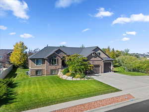 Craftsman-style home with concrete driveway and an attached garage