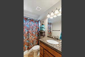 Bathroom featuring vanity, a textured ceiling, and light tile patterned floors