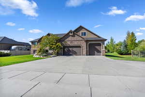 View of front of house featuring concrete driveway and an attached garage