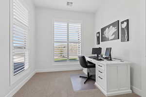 Office space featuring light carpet and baseboards
