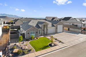 View of front facade featuring a residential view, driveway, a garage, and stucco siding
