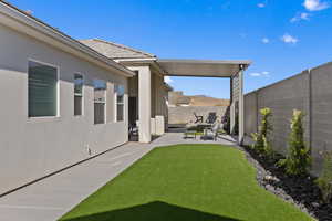 Fenced backyard with a patio