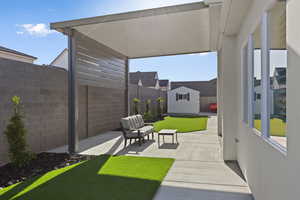 Fenced backyard with a patio and a shed