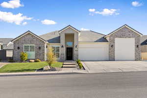 Single story home featuring a garage, concrete driveway, a front lawn, and a tile roof