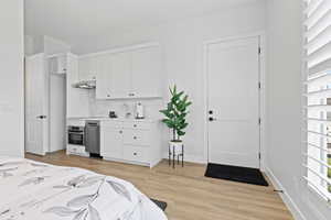 Bedroom featuring light wood finished floors and baseboards