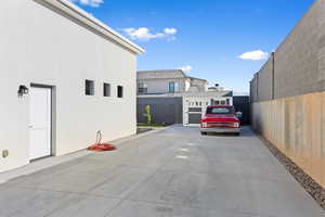 View of vehicle parking featuring a fenced backyard