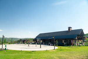View of home's community with a yard and a patio area