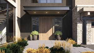 Doorway to property with a patio area