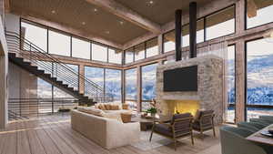 Living room with a stone fireplace, a high ceiling, expansive windows, hardwood / wood-style floors, and recessed lighting