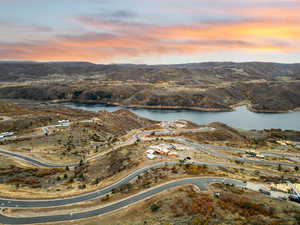 Aerial view of property and surrounding area featuring a water and mountain view