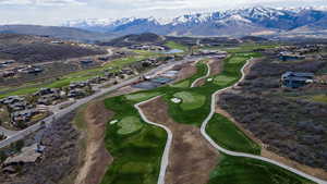 Aerial view of property's location with a local golf course and a water and mountain view