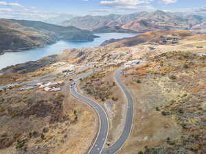 Aerial view of property's location featuring a water and mountain view