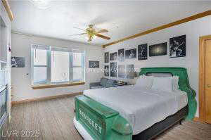 Bedroom with ornamental molding and a ceiling fan