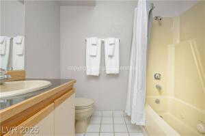 Full bath featuring vanity, shower / bath combination with curtain, and light tile patterned floors