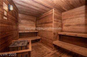 Relaxing sauna / steam room with wood ceiling, wooden walls, and wood finished floors
