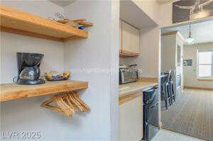 Kitchen featuring light countertops, pendant lighting, light carpet, and oven