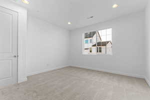 Unfurnished room featuring light colored carpet and recessed lighting