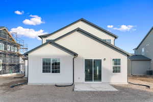 Back of house with stucco siding and a patio area