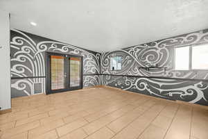 Spacious family room with tile floor, double French doors to driveway