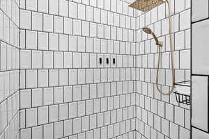 Full bath featuring a tile shower