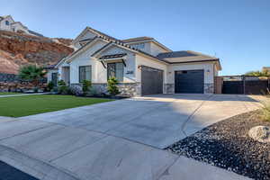 Modern inspired farmhouse featuring concrete driveway, stone siding, an attached garage, and stucco siding