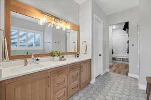 Bathroom featuring double vanity and light tile patterned floors