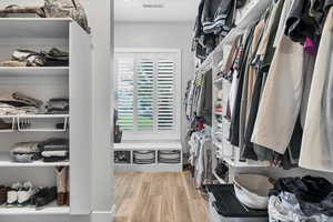 Spacious closet with light wood finished floors