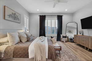Bedroom featuring multiple windows, wood finished floors, a ceiling fan, and recessed lighting