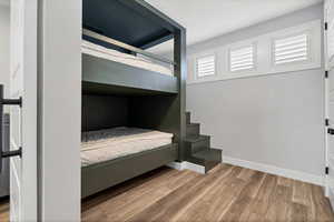 Bedroom with light wood-style flooring and baseboards