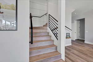 Staircase featuring wood finished floors and baseboards
