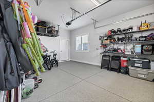 Garage with baseboards and a garage door opener