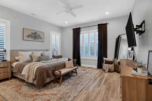 Bedroom with light wood-style floors, recessed lighting, and a ceiling fan