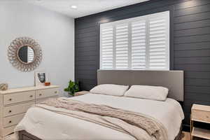 Bedroom with wood walls