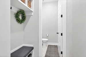 Bathroom with light tile patterned floors and toilet