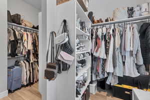 Walk in closet with light wood-type flooring