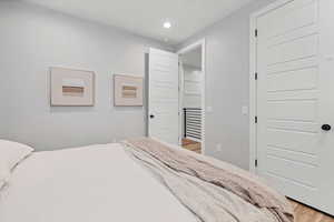 Bedroom featuring light wood-style flooring and recessed lighting