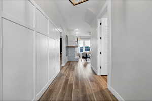 Corridor with dark wood finished floors and recessed lighting