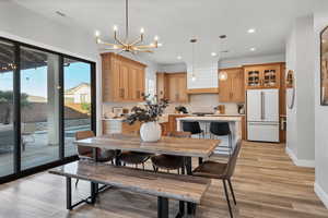 Dining room featuring recessed lighting, light wood-style flooring, and a chandelier